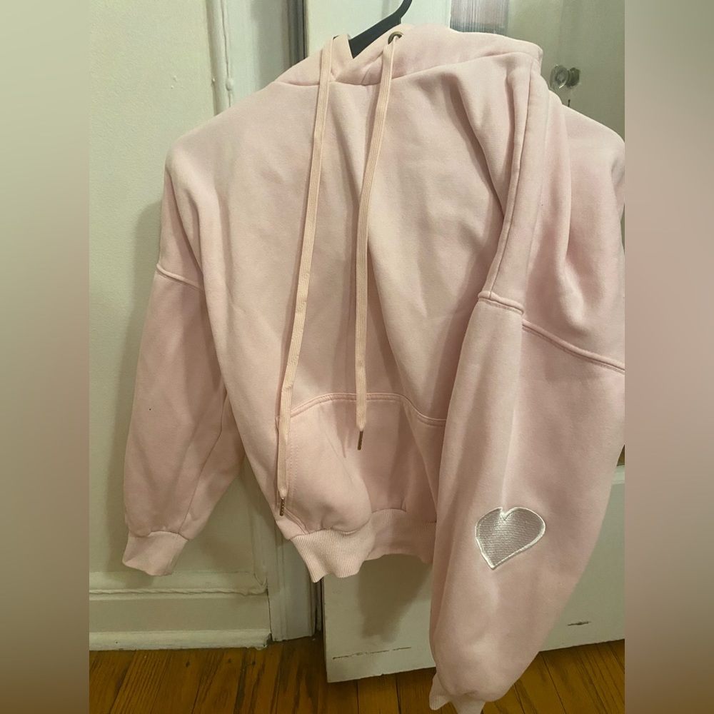 Pink hoodie with heart on sleeve